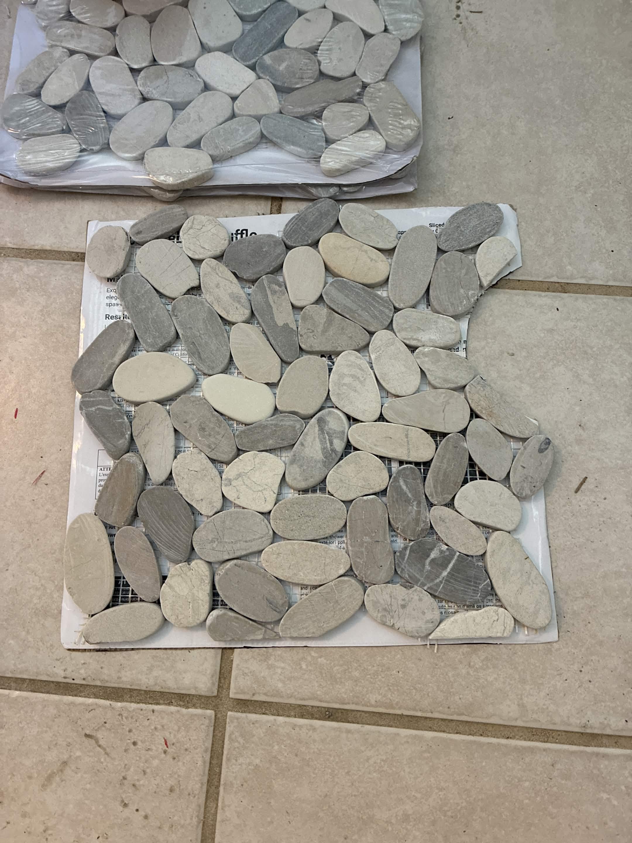 Sliced-pebble mosaic tile sheets selected for tub surround accent band