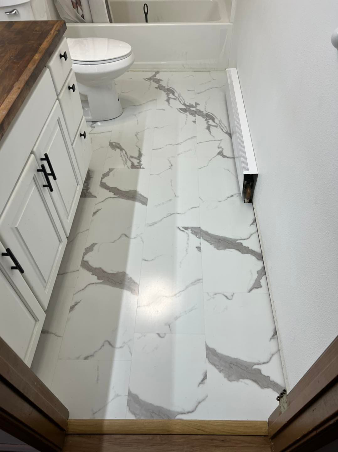 Marble-look tile flooring installed in Juneau bathroom by Sourdough Construction